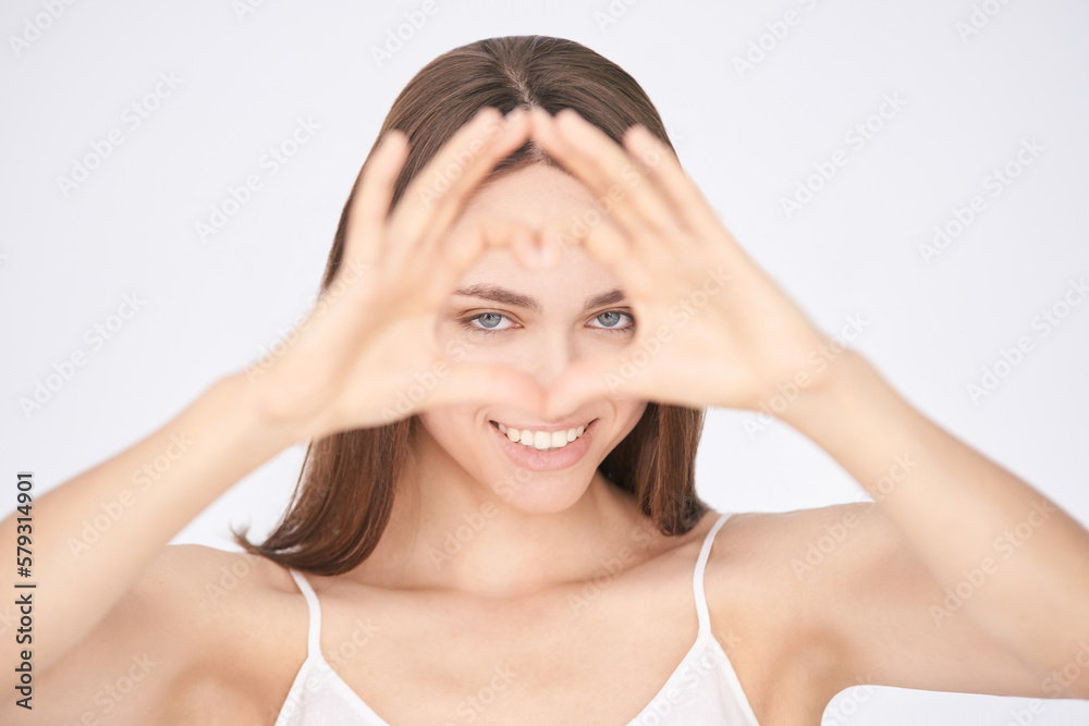 heart love sign near eyes. young girl gesture. heart love sign near eyes. young girl gesture.