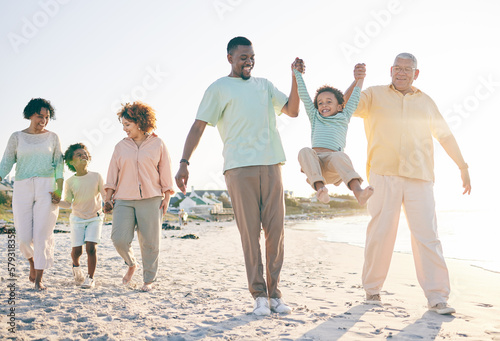 Family, grandparents and kids at beach, holding hands and jump with swing, happiness or bonding on holiday. Parents, children and senior people for love, vacation or summer sunshine in morning by sea