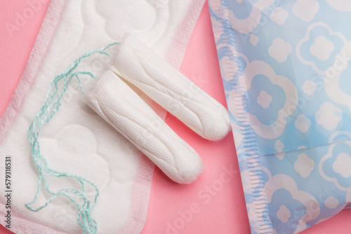 Menstruation concept, sanitary pads and tampons on pink layout, gynecology background
