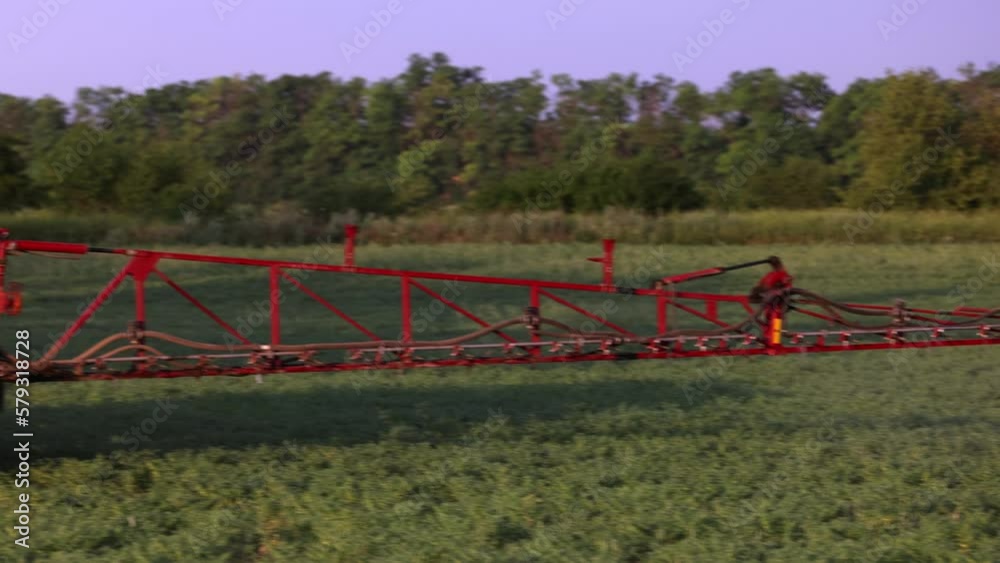 Agricultural sprayer spraying pesticides on chickpea field. Farmer on a tractor Treats the field with chemicals against pests, insects and plant diseases. Taking care of the Crop. slow motion video Agricultural sprayer spraying pesticides on chickpea field. Farmer on a tractor Treats the field with chemicals against pests, insects and plant diseases. Taking care of the Crop. slow motion video