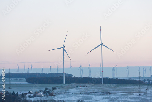 Wind turbines generate energy power electricity during the evening. winter landscape, pastel, wind turbines, clean energy