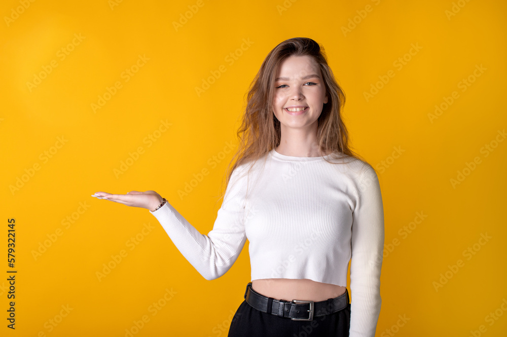 Portrait of cheerful girl showing blank space copy advertisement isolated on bright background Portrait of cheerful girl showing blank space copy advertisement isolated on bright background