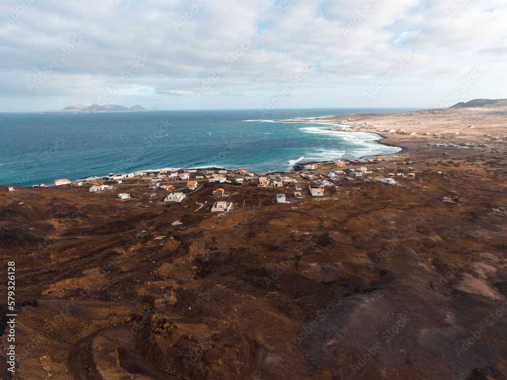 Aerial photos of Calhau, a village located near an inactive volcano in Sao Vicente Island, Cabo Verde, offer a unique perspective of the towering volcanic landscape, rugged terrain, and vibrant coasta Aerial photos of Calhau, a village located near an inactive volcano in Sao Vicente Island, Cabo Verde, offer a unique perspective of the towering volcanic landscape, rugged terrain, and vibrant coasta