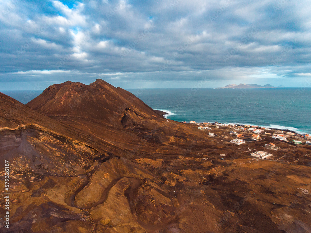 Aerial photos of Calhau, a village located near an inactive volcano in Sao Vicente Island, Cabo Verde, offer a unique perspective of the towering volcanic landscape, rugged terrain, and vibrant coasta