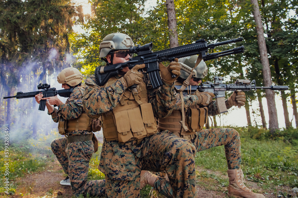 Soldier fighters standing together with guns. Group portrait of US army elite members, private military company servicemen, anti terrorist squad