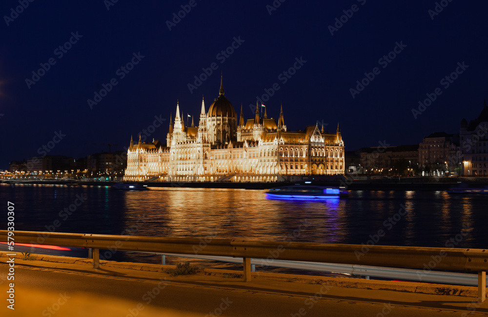 View on Budapest Parliament building across the river at night. Illuminated landmark.
