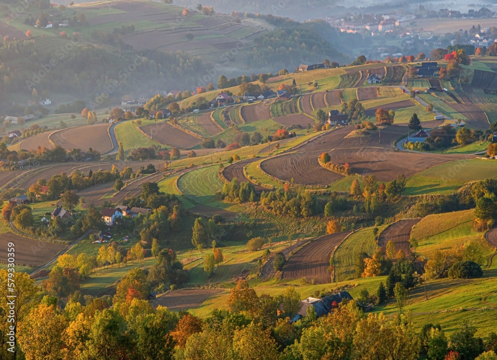 Fototapeta premium Colors of the autumn rural landscape of the hills in Slovakia, Podpolanie region, Hrinova. Beauty of an ecologically cultivated landscape