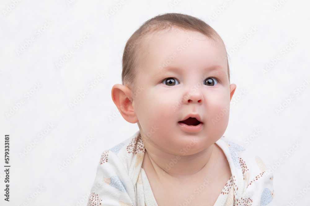 Six month old baby on a white background. Happy boy mid-range. Conceptual photo of fatherhood and motherhood.Alpha generation. Six month old baby on a white background. Happy boy mid-range. Conceptual photo of fatherhood and motherhood.Alpha generation.