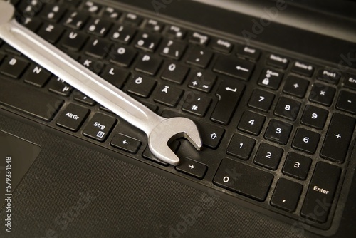 wrench on a keyboard - IT-support maintenance or help with computer problems