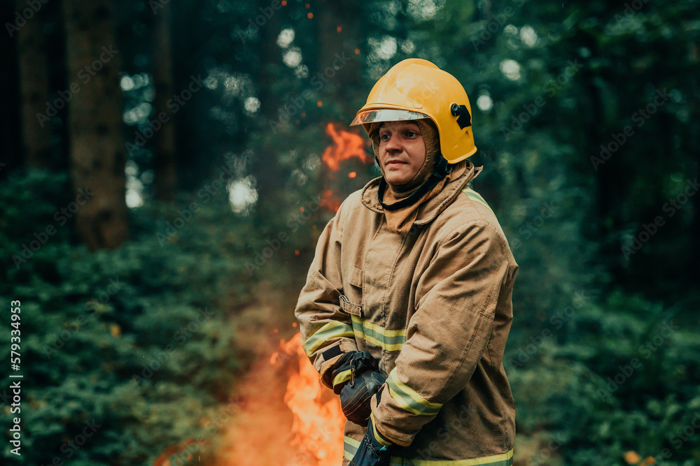 Firefighter at job. Firefighter in dangerous forest areas surrounded by strong fire. Concept of the work of the fire service