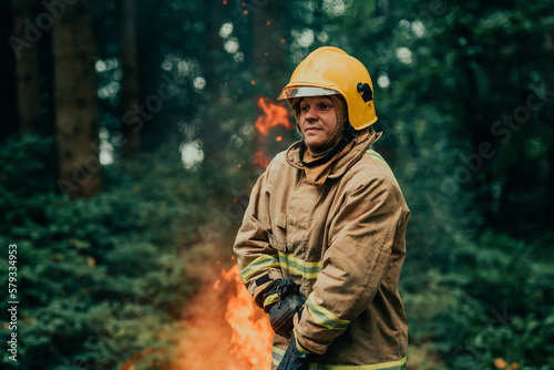 Firefighter at job. Firefighter in dangerous forest areas surrounded by strong fire. Concept of the work of the fire service © .shock
