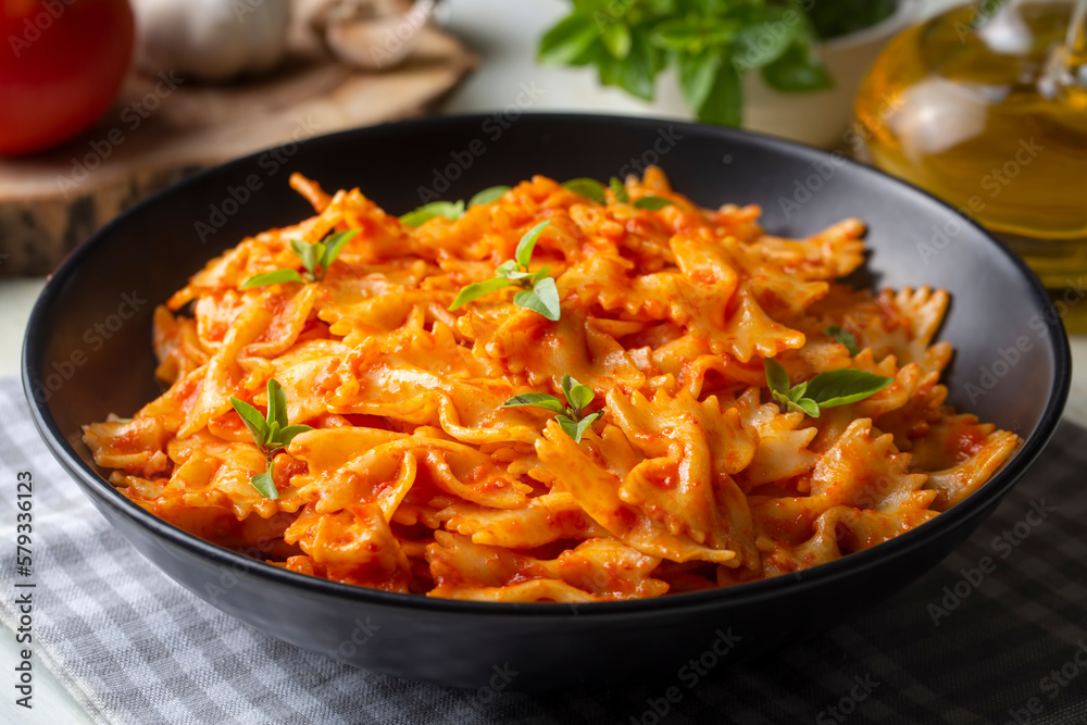 Farfalle pasta with tomato sauce, bow tie pasta tomatoes sauce (Turkish name; domatesli kelebek makarna) Farfalle pasta with tomato sauce, bow tie pasta tomatoes sauce (Turkish name; domatesli kelebek makarna)