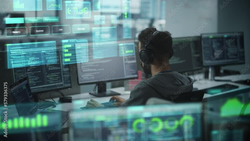 Software Programmer Working on Computer, Engineering Neural Networking, Machine Learning, Big Data, Artificial Intelligence. Animated Coding Language Projection Overlayes the Screen. Back View Shot