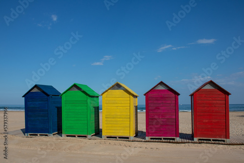 Colorful wooden changing rooms on the beach of Cullera, Valencia, Spain © Manoli Pérez