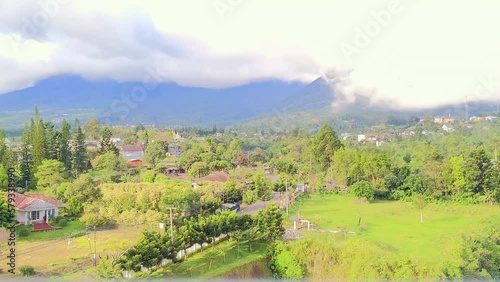 Time lapse. Clouds sensation moving down mountain at day. View from Cipanas City, West Java, Indonesia photo
