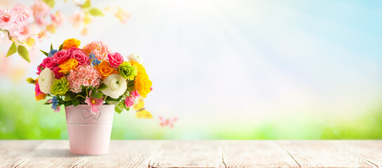 Beautiful spring flowers in vase on white wooden table. Festive still life with copy space.