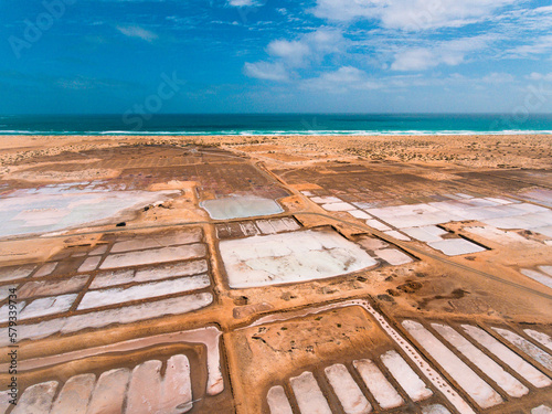Aerial photos of Salines in Santa Maria, Sal Island in Cabo Verde showcase stunning salt flats, colorful patterns created by salt ponds, machinery used for salt harvesting