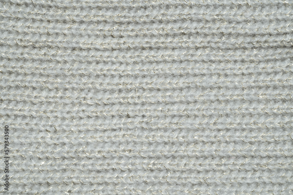 light grey knit sweater pattern with gold tinsel. Cozy nordic background. Ornate wool texture light grey knit sweater pattern with gold tinsel. Cozy nordic background. Ornate wool texture