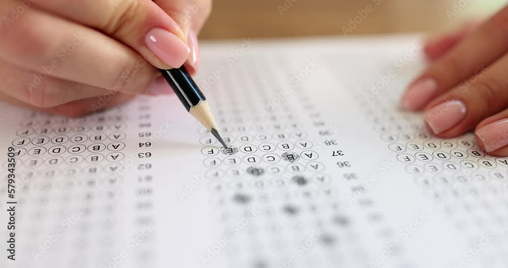 Student hand testing on a test exam with pencil Student hand testing on a test exam with pencil