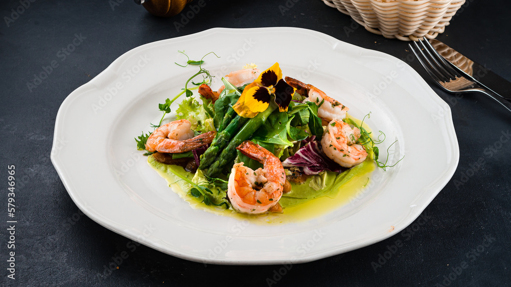 Green salad with shrimps, asparagus, lettuce and green sauce. Green salad with shrimps, asparagus, lettuce and green sauce.