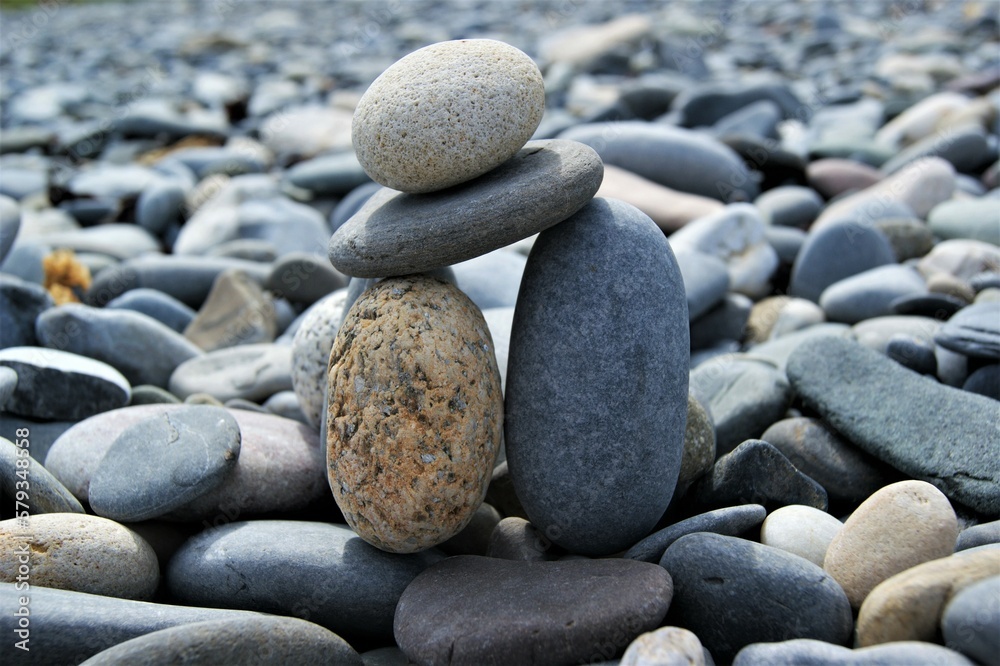 A tower of pebbles on a stony beach. A tower of pebbles on a stony beach.