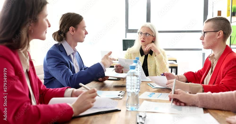 Mature CEO business leader with team of colleagues are discussing project Mature CEO business leader with team of colleagues are discussing project