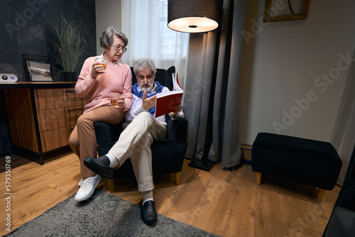 Elderly male with a lady are sitting in an armchair