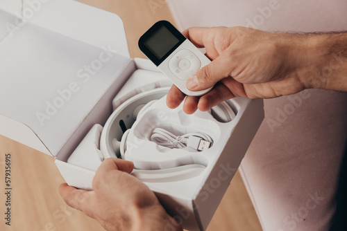 Man unbox a neck device massager