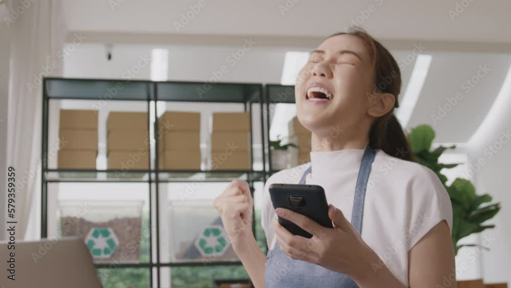 Smart SME money lending for eco friendly online shop store. Young adult people asia woman happy smile looking at good news on phone joy win reward at home office. Winner ESG e-commerce startup vendor. Smart SME money lending for eco friendly online shop store. Young adult people asia woman happy smile looking at good news on phone joy win reward at home office. Winner ESG e-commerce startup vendor.