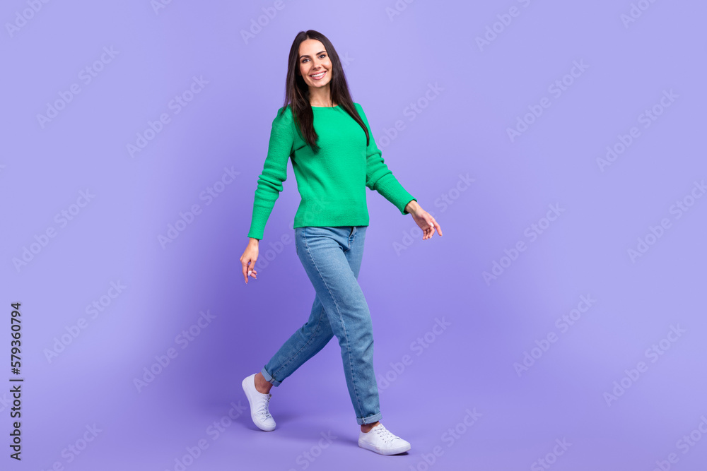 Full length profile side photo of young woman walking forward shopping store mall center isolated purple color background