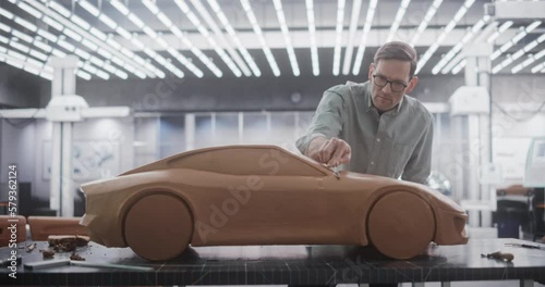 Wallpaper Mural Creative Automotive Designer Working on a Prototype Car Out of Polymer Modeling Clay. Focused Professional Modeler Contemplating the 3D Sculpture, Looking Thoughtfully at the Model Torontodigital.ca