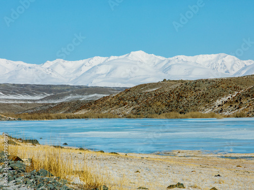 View from Tarahta river valley to South Chui ridge in winter day. Russia South Of Western Siberia, Altai Mountains. Desert mountains covered with snow near village of Kosh-Agach