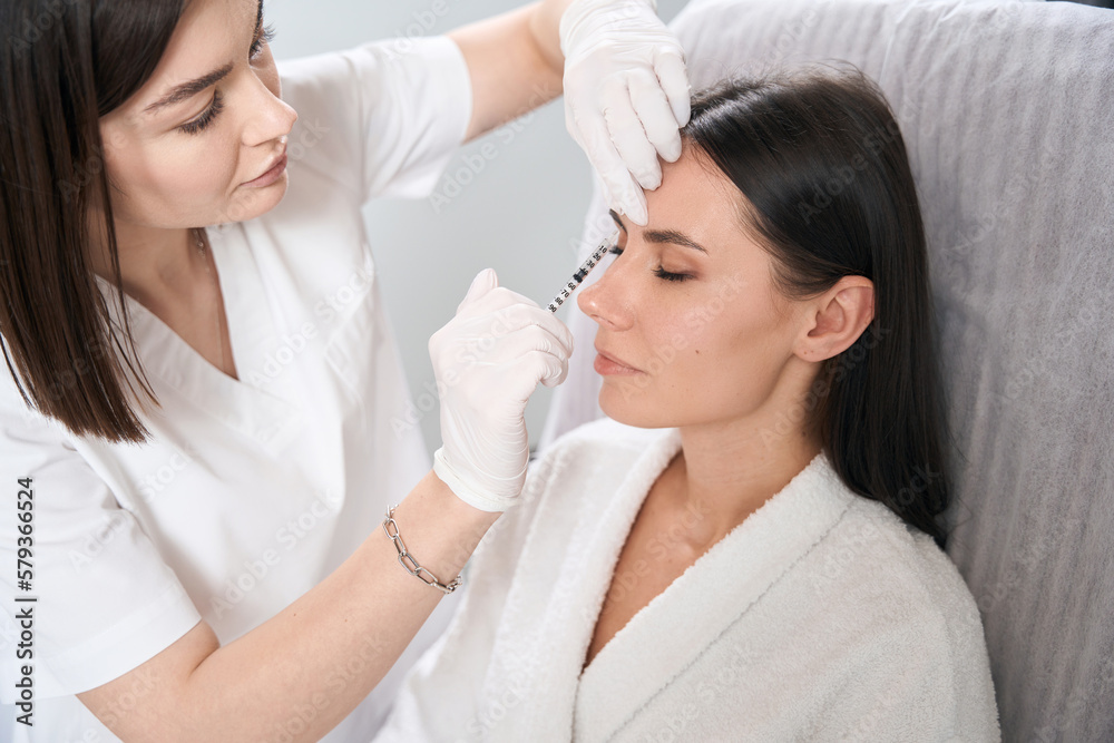 Pretty lady on injection procedure for facial skin nutrition Pretty lady on injection procedure for facial skin nutrition