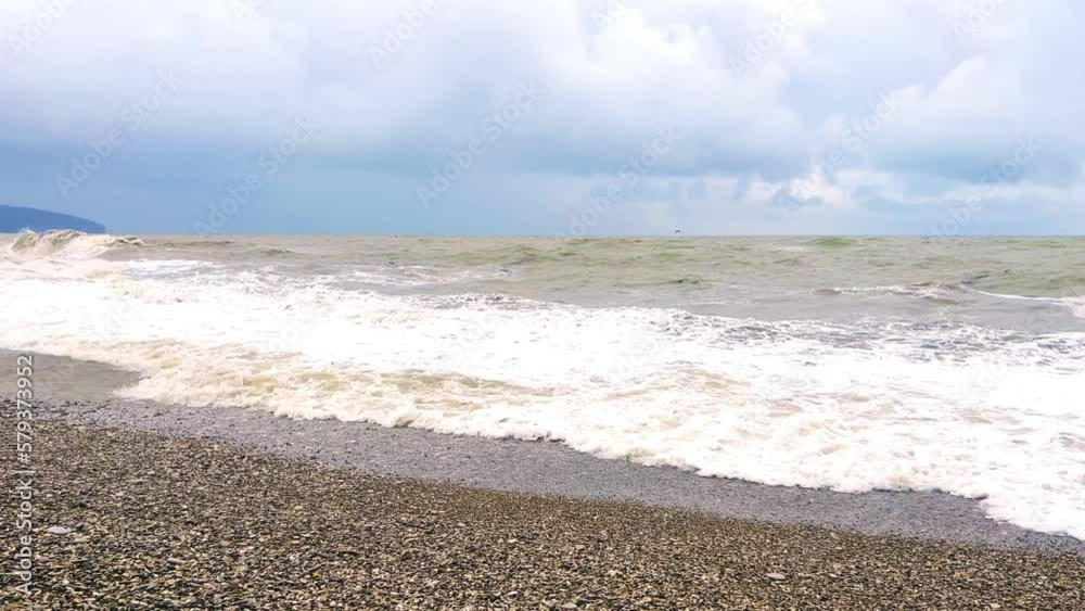 Powerful sea waves are crashing on the Black Sea coast. Waves splash on the beach with pebbles during a storm. Storm at sea. Panoramic view of the Black Sea. Russia. Sunset on the beach. 4K Powerful sea waves are crashing on the Black Sea coast. Waves splash on the beach with pebbles during a storm. Storm at sea. Panoramic view of the Black Sea. Russia. Sunset on the beach. 4K