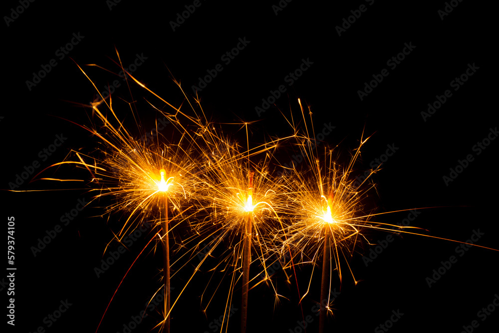 yellow fireworks sparks celebrate the new year Christmas holiday festival party festive night atmosphere on a black background