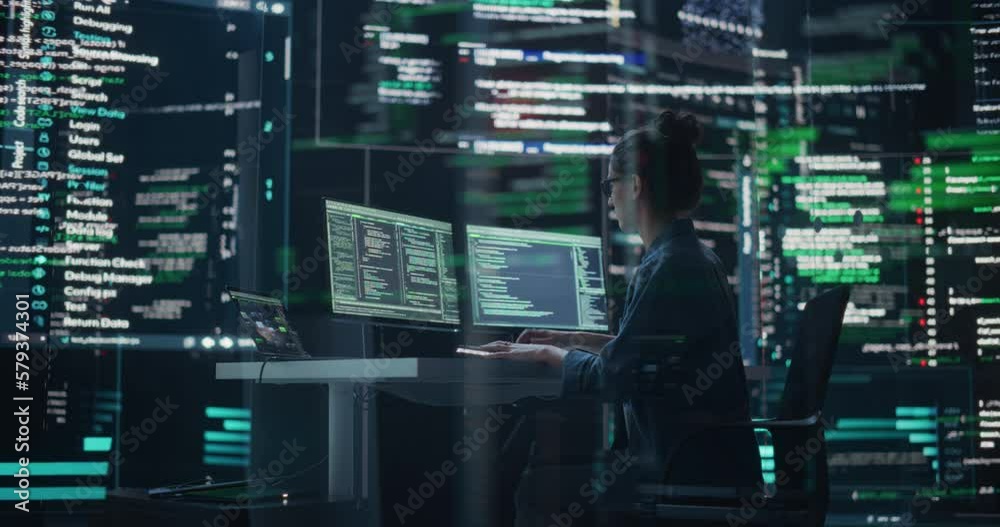 Dolly Shot of Female Programmer Working in a Monitoring Control Room, Surrounded by Big Screens Displaying Lines of Programming Language Code. Portrait of Woman Creating a Software and Coding Dolly Shot of Female Programmer Working in a Monitoring Control Room, Surrounded by Big Screens Displaying Lines of Programming Language Code. Portrait of Woman Creating a Software and Coding