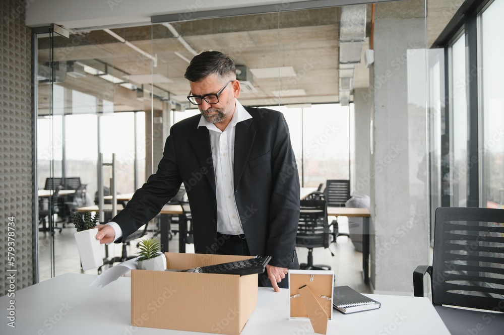 old employee leaving office with the box full of belongings old employee leaving office with the box full of belongings