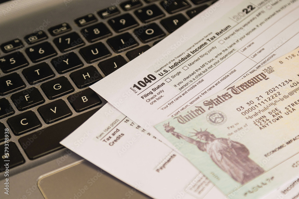 IRS 1040 tax forms , United States tax form, a laptop on a desk. US individual income tax return. Accountant working with US tax forms IRS 1040 tax forms , United States tax form, a laptop on a desk. US individual income tax return. Accountant working with US tax forms