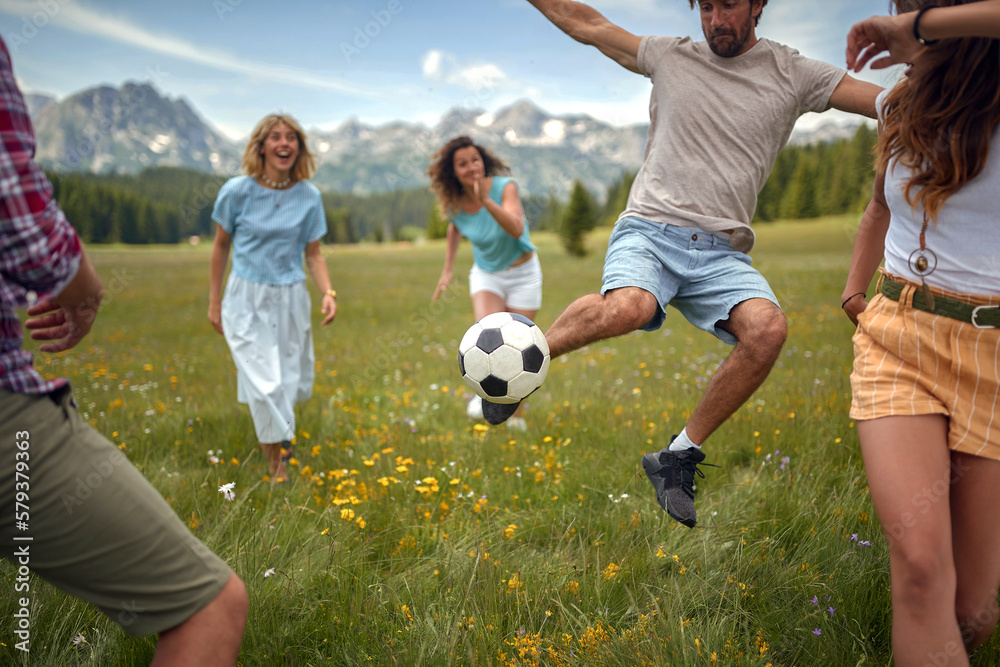 people playing ball in the nature at meadow people playing ball in the nature at meadow