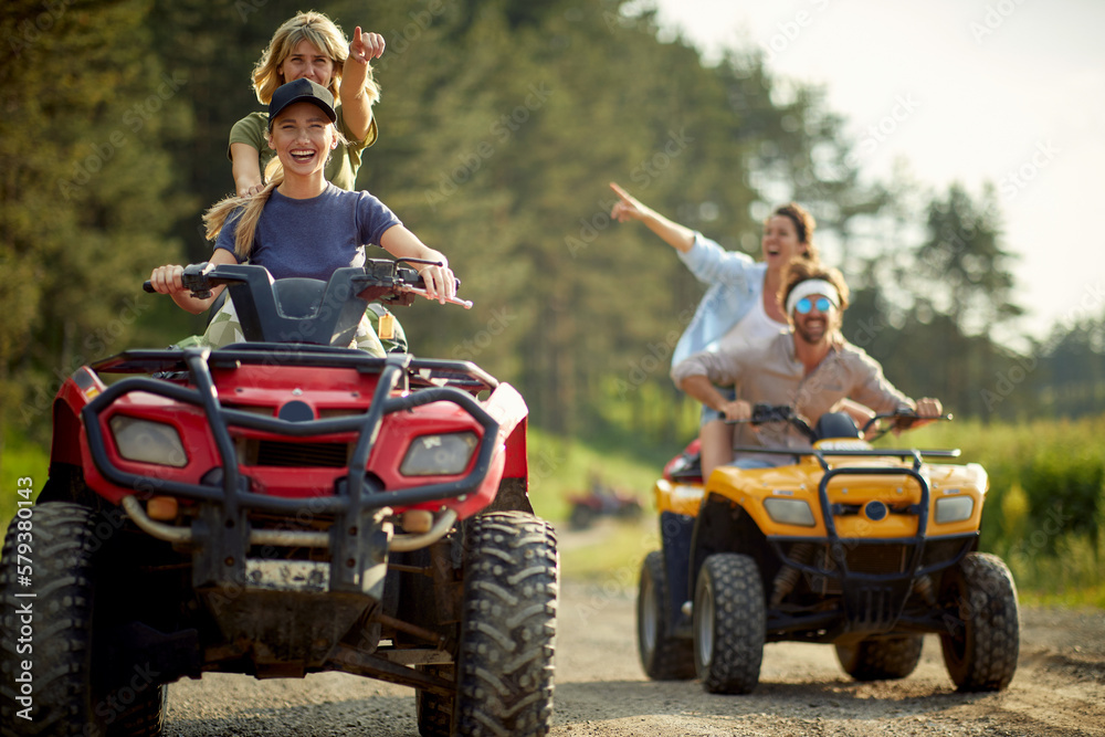 Fototapeta premium Group of active friends driving quads together