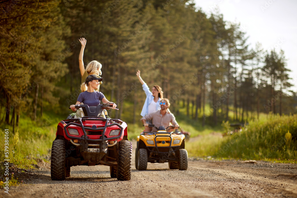 Fototapeta premium Group of caucasian friends driving quads together