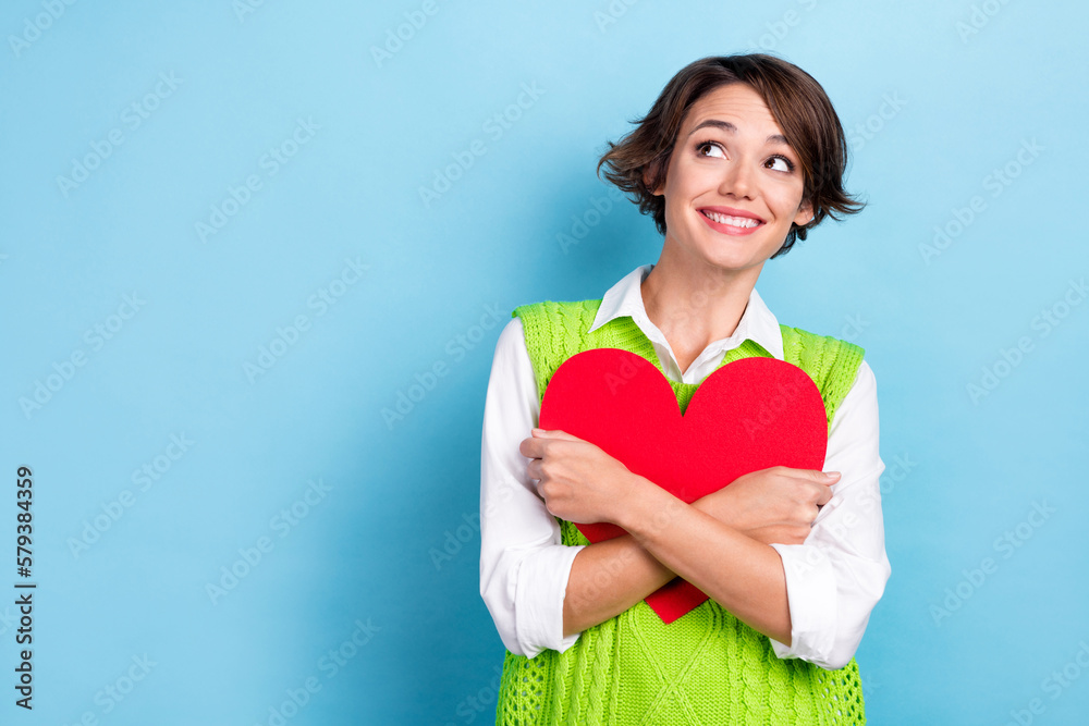Photo of lovely adorable lady girlfriend hold red paper card look empty space interesting offer isolated on cyan color background Photo of lovely adorable lady girlfriend hold red paper card look empty space interesting offer isolated on cyan color background