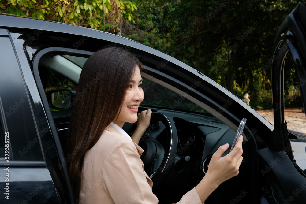 woman opening car door looking at phone woman opening car door looking at phone