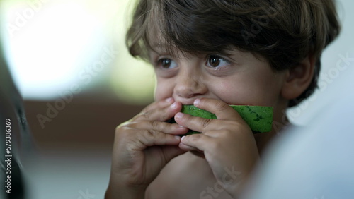 Small boy eating watermelon fruit. Child eats healthy snack food