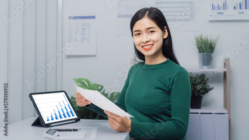 Wallpaper Mural Young Asian household woman busy with bills and taxation, using calculator, make payment on tablet of family budget. Torontodigital.ca