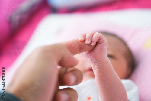 Portrait of a newborn Asian baby girl sleep on the bed , cute Fat baby 5 day.