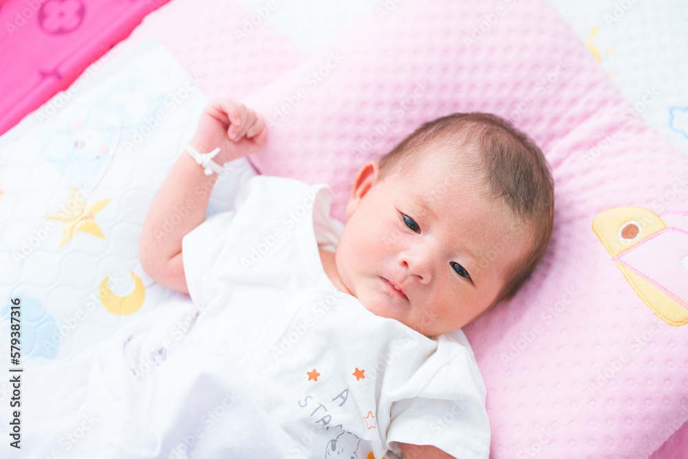 Portrait of a newborn Asian baby girl sleep on the bed , cute Fat baby 5 day. Portrait of a newborn Asian baby girl sleep on the bed , cute Fat baby 5 day.