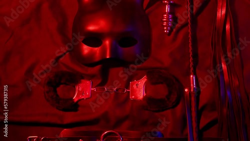 Set of erotic sex toys for adults. Handcuffs, leather whip flogger, mask, choker and butt plug for sex with domination and submission