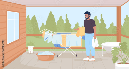 Drying clothes without dryer for energy saving flat color vector illustration. Man using rack for clean towels. Hero image. Fully editable 2D simple cartoon characters with back porch on background