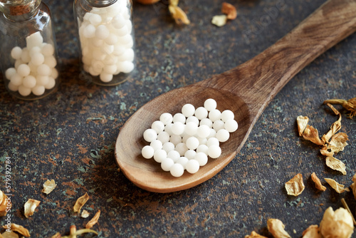 Close up of homeopathic globules on a wooden spoon